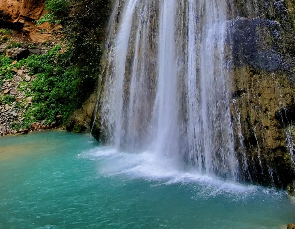 stunning waterfall gushes amidst the serene beauty of a deep canyon.