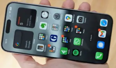 A person shows iPhone 15 [pro max features with the home screen displayed.
